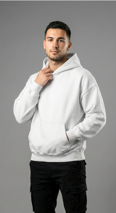 Man wearing a white hoodie and black pants on a gray background